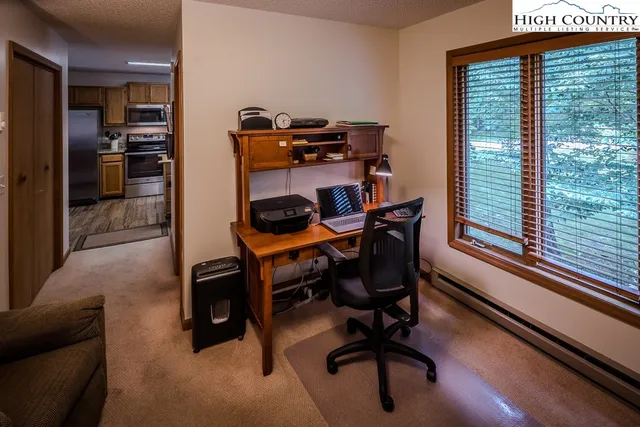 a view of workspace with furniture and windows