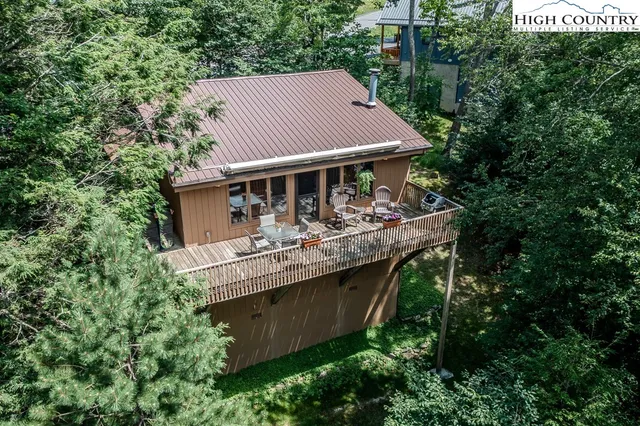 aerial view of a house with a yard balcony and furniture