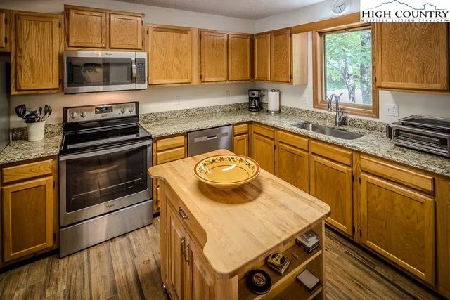 a kitchen with a stove a sink and a microwave