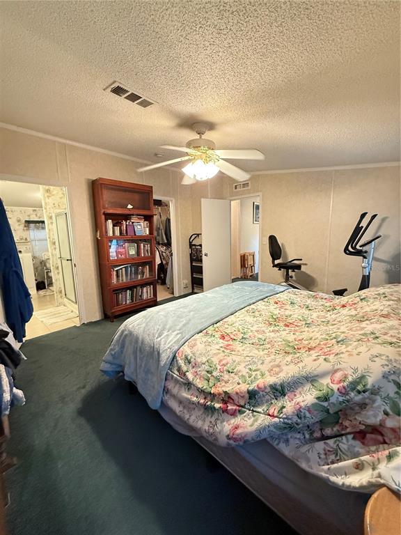 5109 Southwest 10th Street Bell, FL 32619 - Photo 13 of 38 a bed sitting in a spacious bedroom next to a window