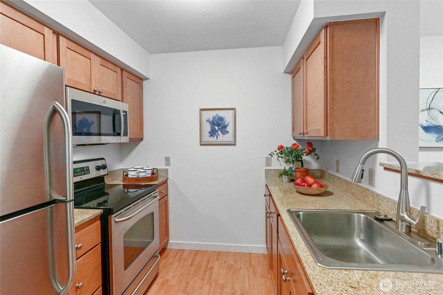 300 High School Road Northeast, Unit 314 Bainbridge Island, WA 98110 - Photo 8 of 36 a kitchen with stainless steel appliances granite countertop a sink and a microwave