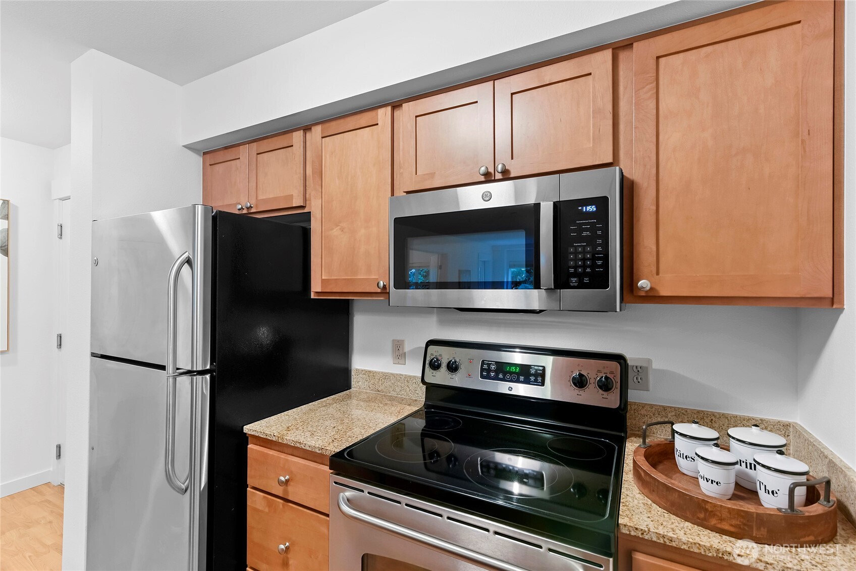 300 High School Road Northeast, Unit 314 Bainbridge Island, WA 98110 - Photo 10 of 36 a kitchen with granite countertop cabinets stainless steel appliances and a counter space