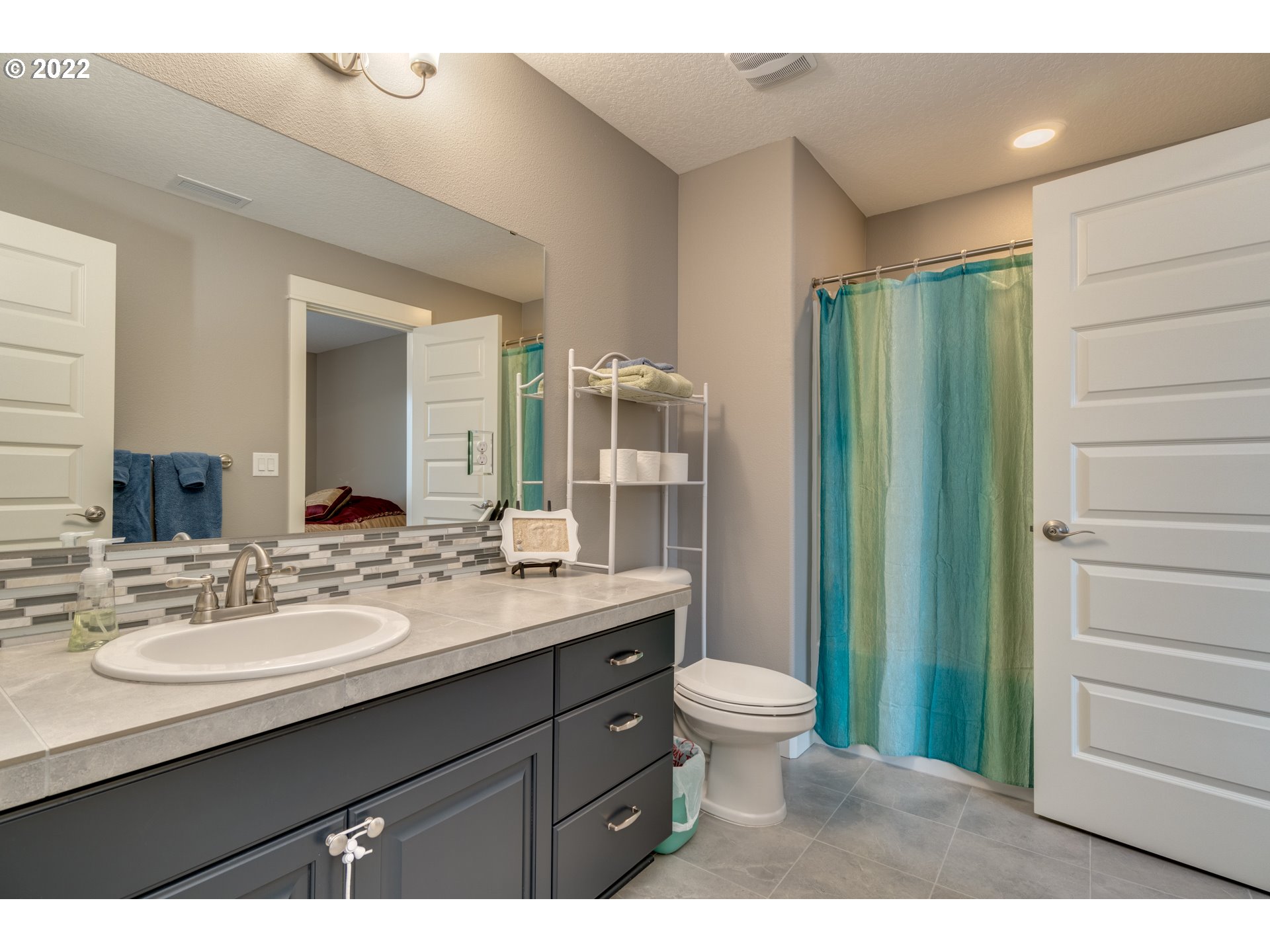 1626 South 46th Place Ridgefield, WA 98642 - Photo 19 of 32 a bathroom with a double vanity sink toilet and shower