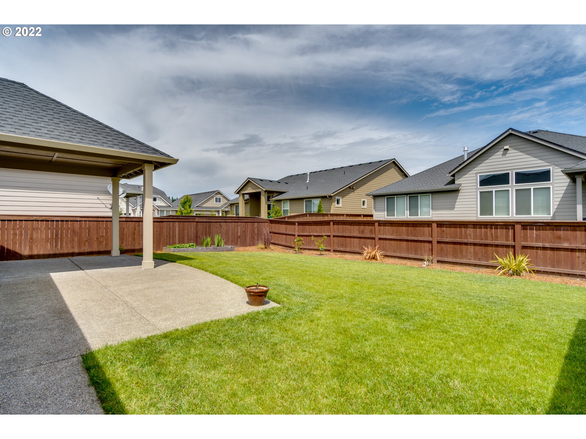 1626 South 46th Place Ridgefield, WA 98642 - Photo 26 of 32 a view of backyard of house with wooden deck and outdoor seating