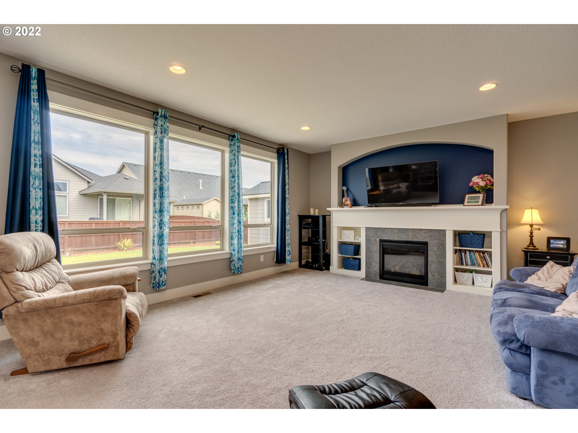 1626 South 46th Place Ridgefield, WA 98642 - Photo 3 of 32 a living room with furniture a fireplace and a flat screen tv