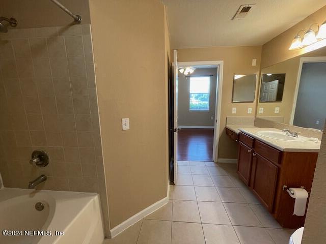 8550 Touchton Road, Unit 2214 Jacksonville, FL 32216 - Photo 33 of 38 a spacious bathroom with a bathtub sink and mirror