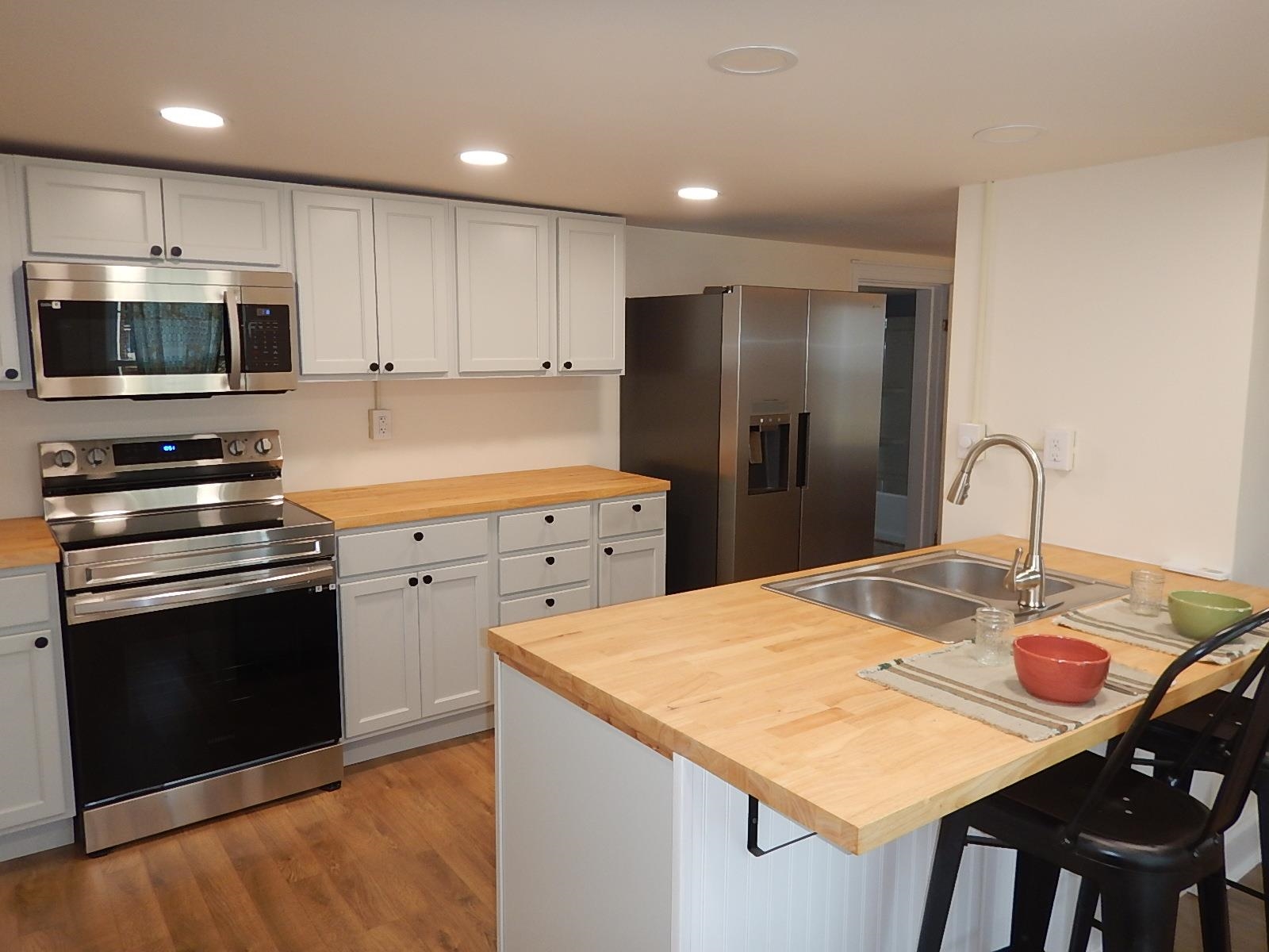 3653 Middlebrook Village Road Middlebrook, VA 24459 - Photo 15 of 48 a kitchen with stainless steel appliances kitchen island granite countertop a kitchen island a stove a sink a refrigerator and cabinets
