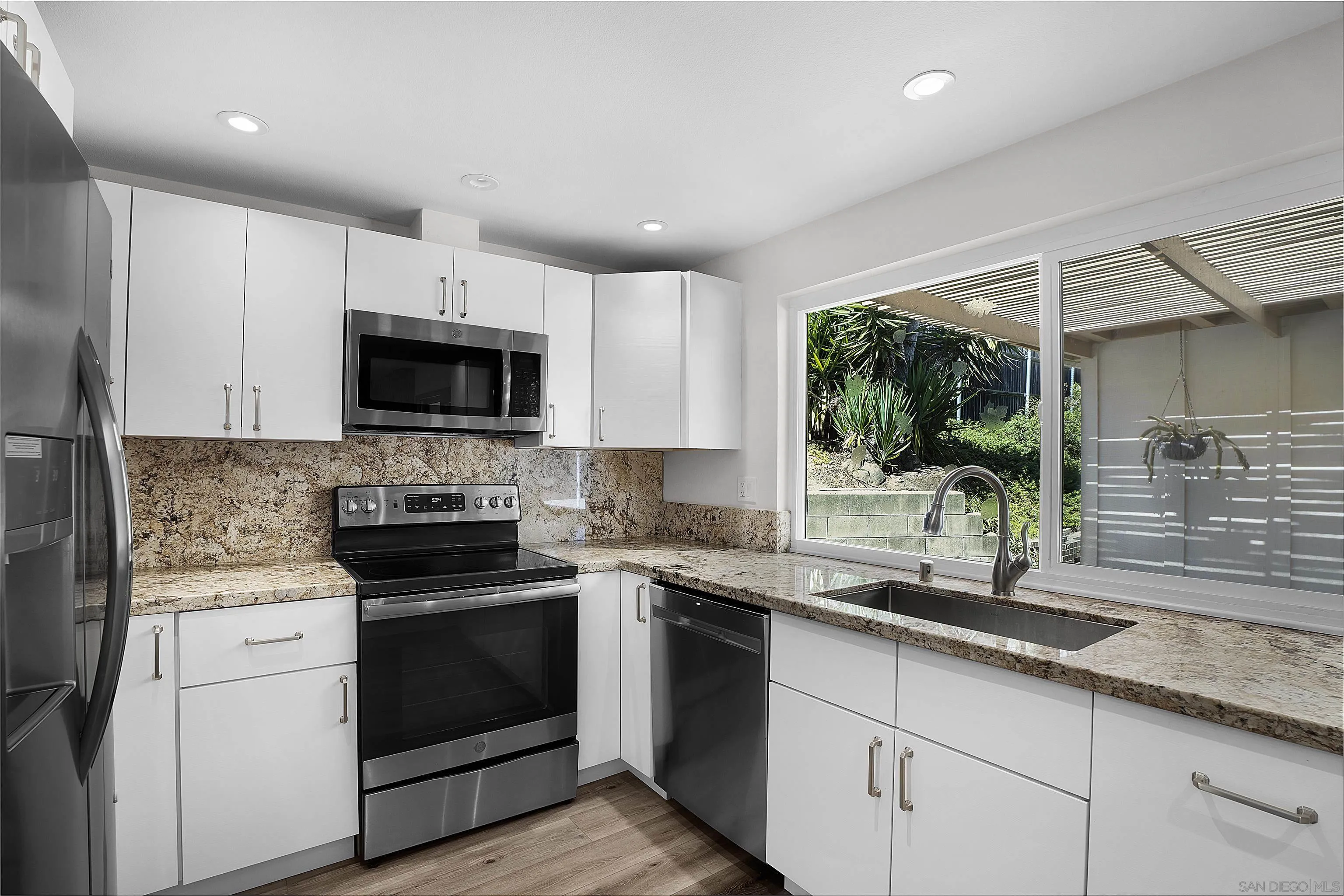 1454 Bathurst Place El Cajon, CA 92020 - Photo 14 of 35 a kitchen with sink a microwave and cabinets