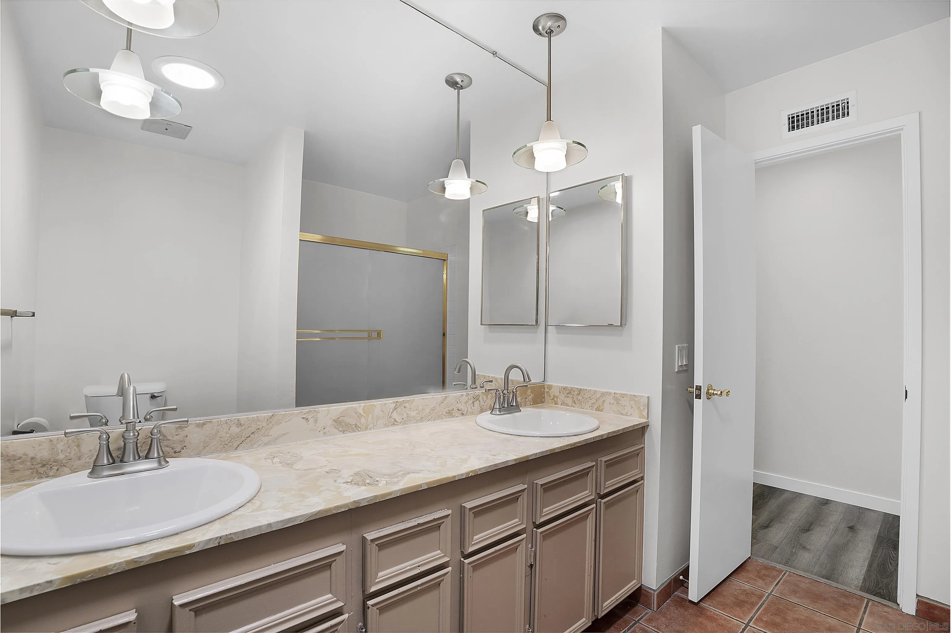 1454 Bathurst Place El Cajon, CA 92020 - Photo 18 of 35 a bathroom with a granite countertop sink a light fixture and a mirror