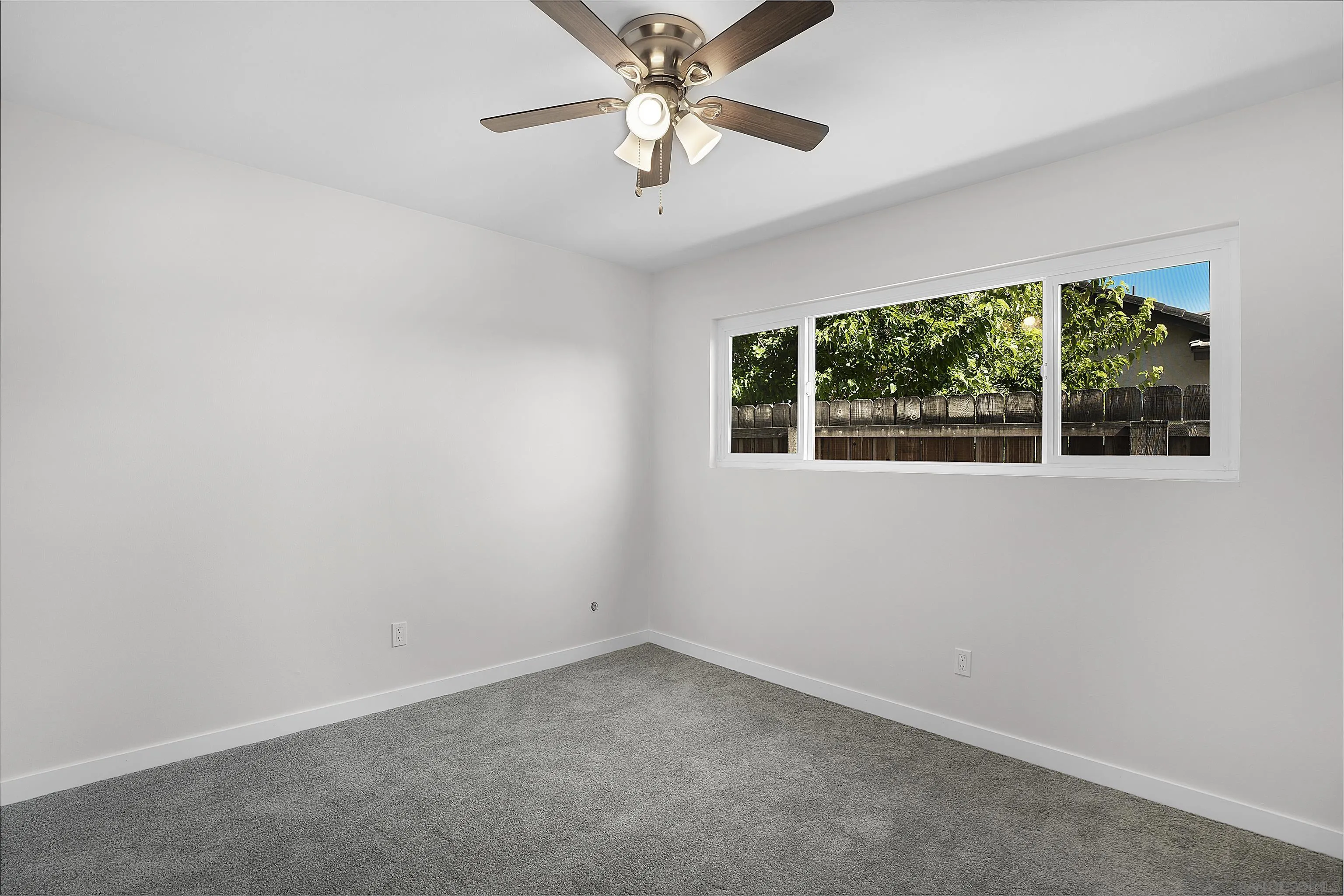 1454 Bathurst Place El Cajon, CA 92020 - Photo 24 of 35 an empty room with a window and a fan