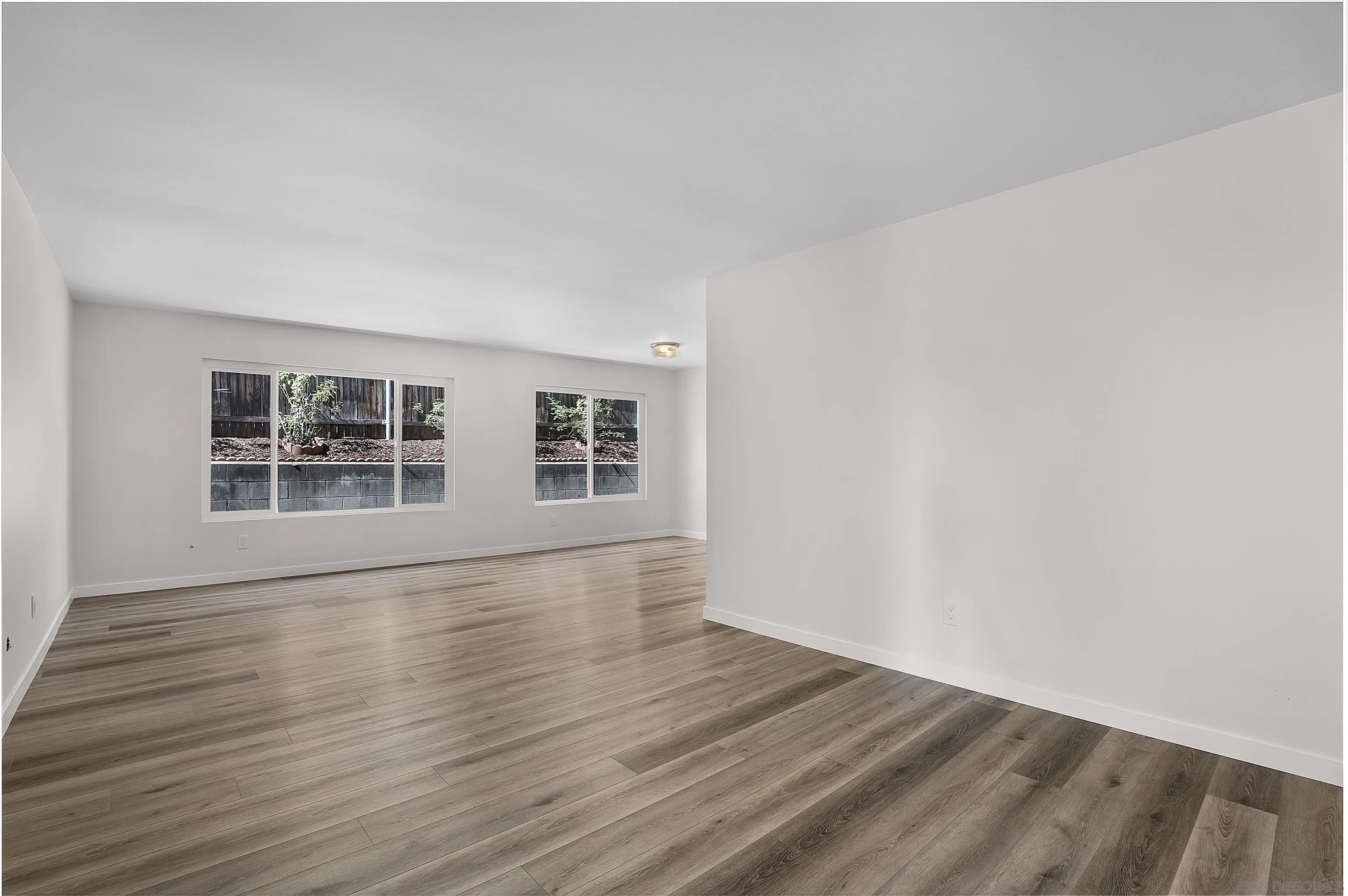 1454 Bathurst Place El Cajon, CA 92020 - Photo 6 of 35 a view of an empty room with wooden floor and windows