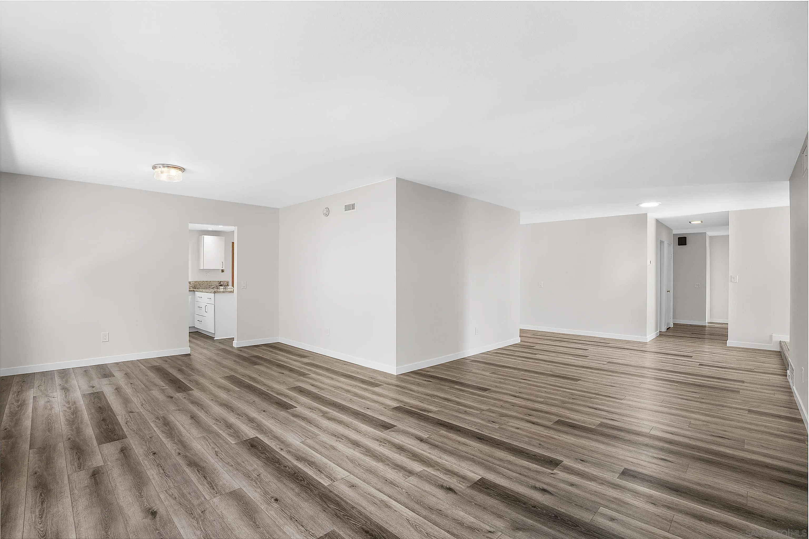 1454 Bathurst Place El Cajon, CA 92020 - Photo 9 of 35 a view of an empty room with wooden floor and a window