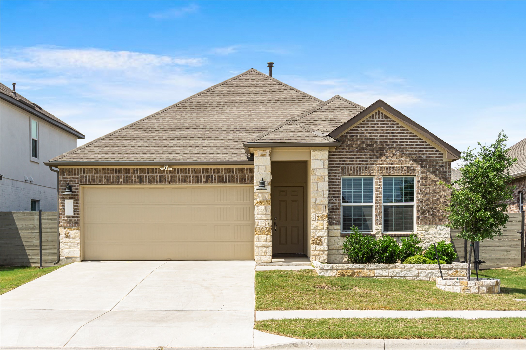 124 Cherry Ridge Road Georgetown, TX 78628 - Photo 1 of 23 Single-story residence featuring a combination brick and stone facade, a two-car garage, and a concrete driveway