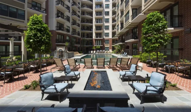 a view of swimming pool with outdoor seating and plants
