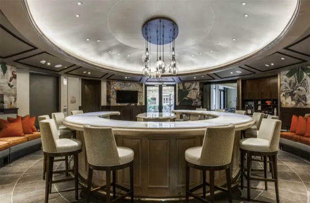 a kitchen with stainless steel appliances granite countertop a dining table and chairs