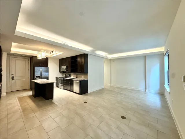 a view of a living room kitchen and a flat screen tv