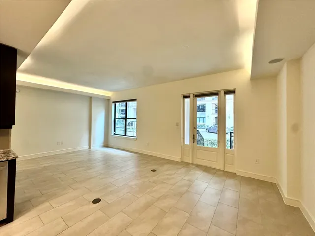 a view of an empty room with glass door