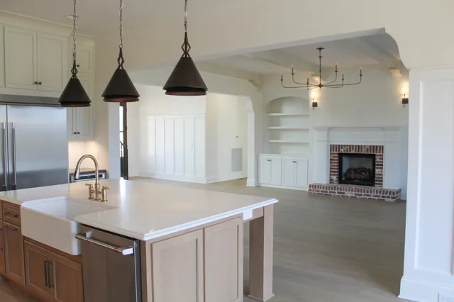 a kitchen with a sink a chandelier and a stove