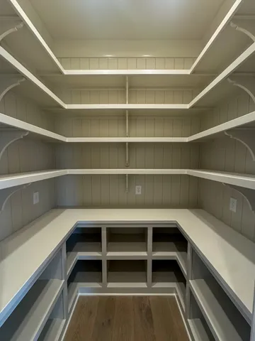 a view of walk in closet with empty racks