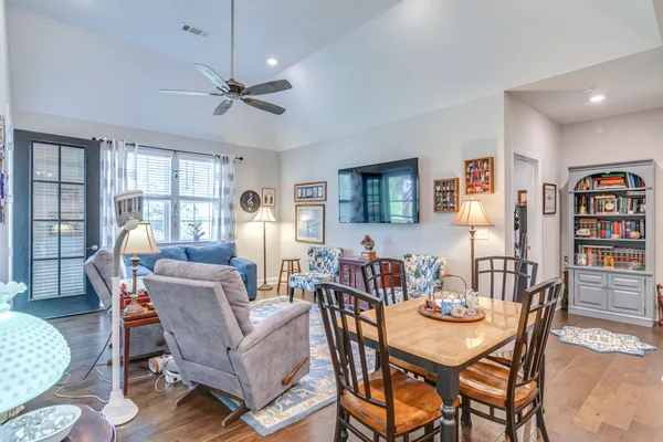 a dining room with furniture a rug and wooden floor
