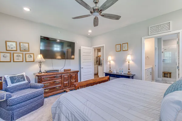 a bedroom with furniture and a flat screen tv