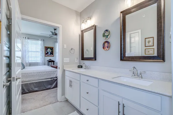 a spacious en suite bathroom with 2 sink tub and a mirror
