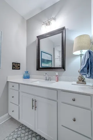 a bathroom with a double vanity sink and a mirror