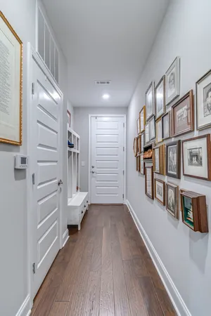 a view of hallway with stairs and wooden floor