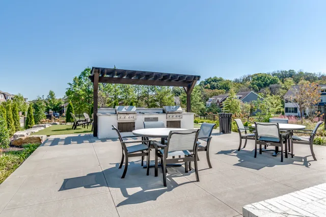 a view of a chairs and table in patio with swimming pool