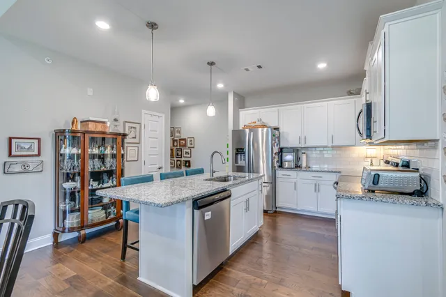 a kitchen with stainless steel appliances granite countertop a sink counter space and cabinets