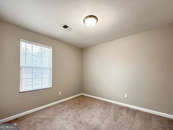 an empty room with a empty space and windows