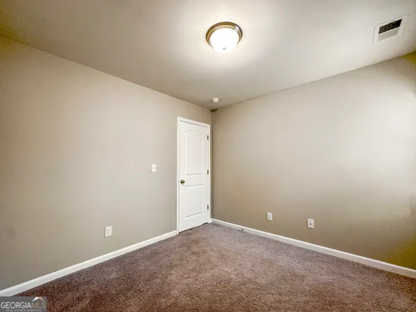 an empty room with a empty space and windows