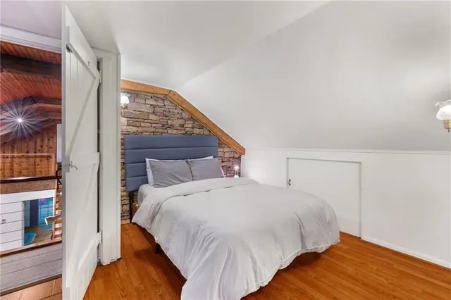 a living room with furniture a flat screen tv and a large window
