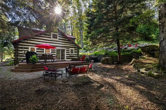 a backyard of a house with lots of green space and fountain