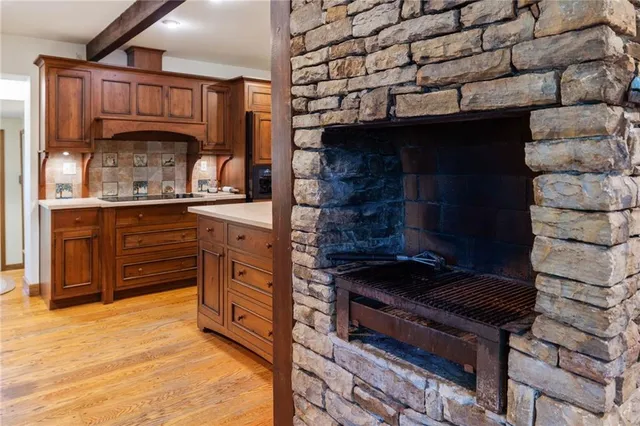 a kitchen with stainless steel appliances granite countertop a stove and a wooden cabinets