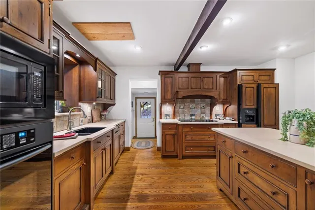 a kitchen with stainless steel appliances granite countertop a stove and cabinets