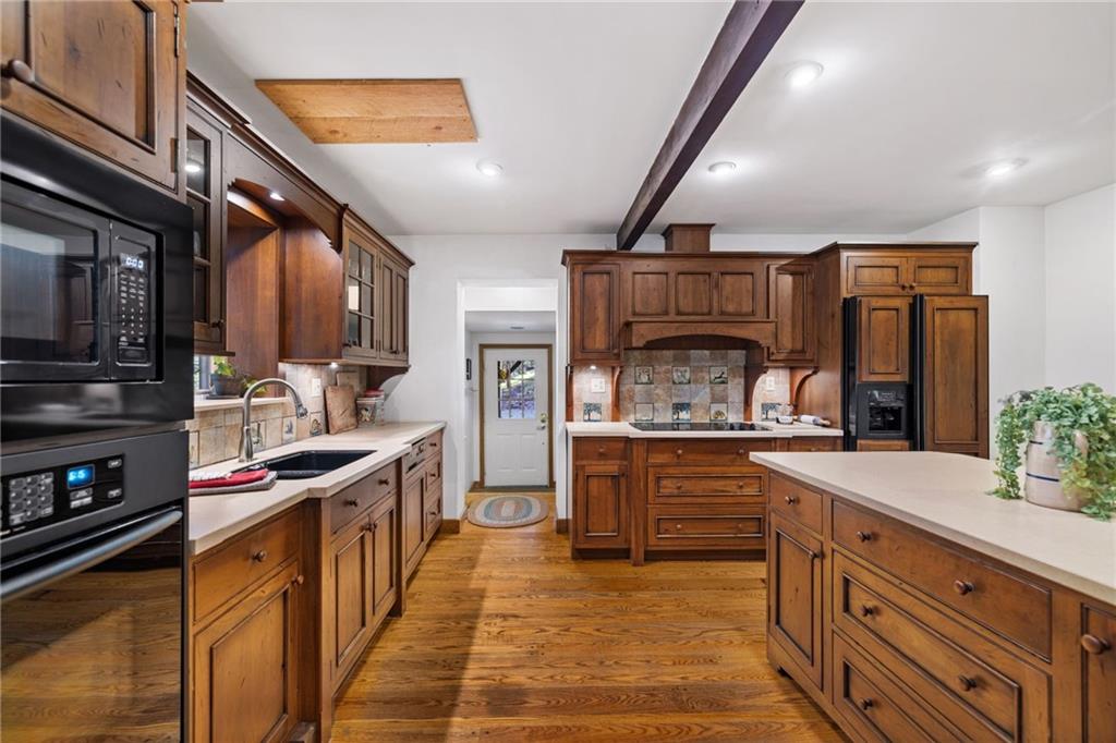 2240 County Line Road Champion, PA 15622 - Photo 8 of 45 a kitchen with stainless steel appliances granite countertop a stove and cabinets