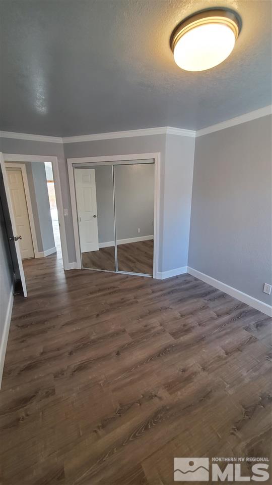 5880 Coyote Ridge Road Reno, NV 89523 - Photo 11 of 28 an empty room with wooden floor and windows