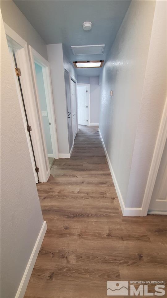5880 Coyote Ridge Road Reno, NV 89523 - Photo 12 of 28 a view of a hallway with wooden floor and staircase