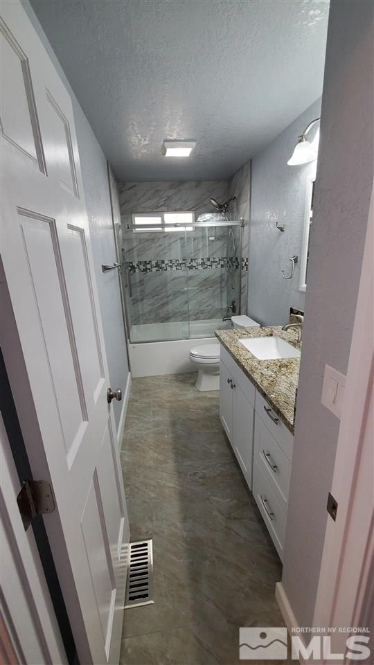 5880 Coyote Ridge Road Reno, NV 89523 - Photo 15 of 28 a bathroom with a granite countertop sink a mirror and a shower