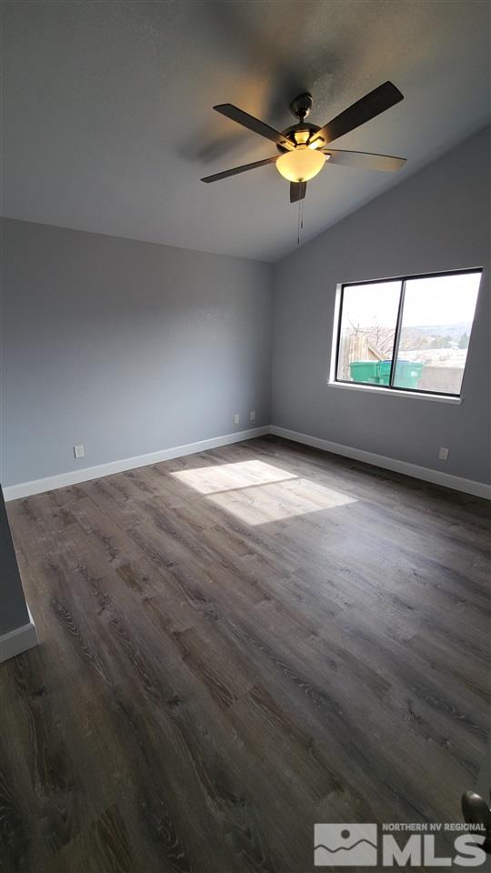 5880 Coyote Ridge Road Reno, NV 89523 - Photo 17 of 28 an empty room with wooden floor and windows