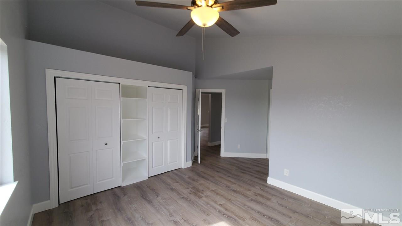 5880 Coyote Ridge Road Reno, NV 89523 - Photo 19 of 28 a view of an empty room and window and wooden floor