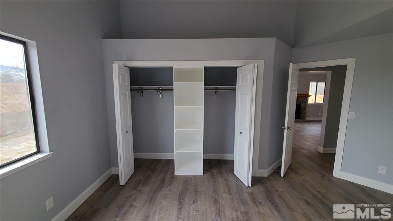 5880 Coyote Ridge Road Reno, NV 89523 - Photo 20 of 28 an empty room with wooden floor and windows