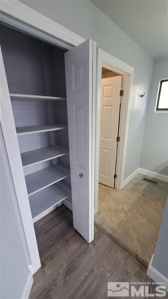 5880 Coyote Ridge Road Reno, NV 89523 - Photo 21 of 28 a view of an empty room with wooden floor and a window