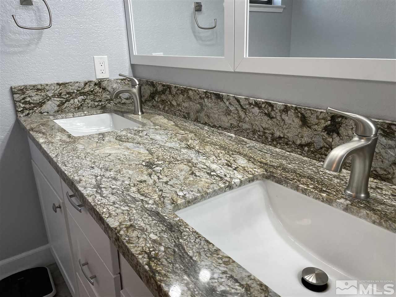 5880 Coyote Ridge Road Reno, NV 89523 - Photo 23 of 28 a bathroom with a granite countertop sink and a mirror