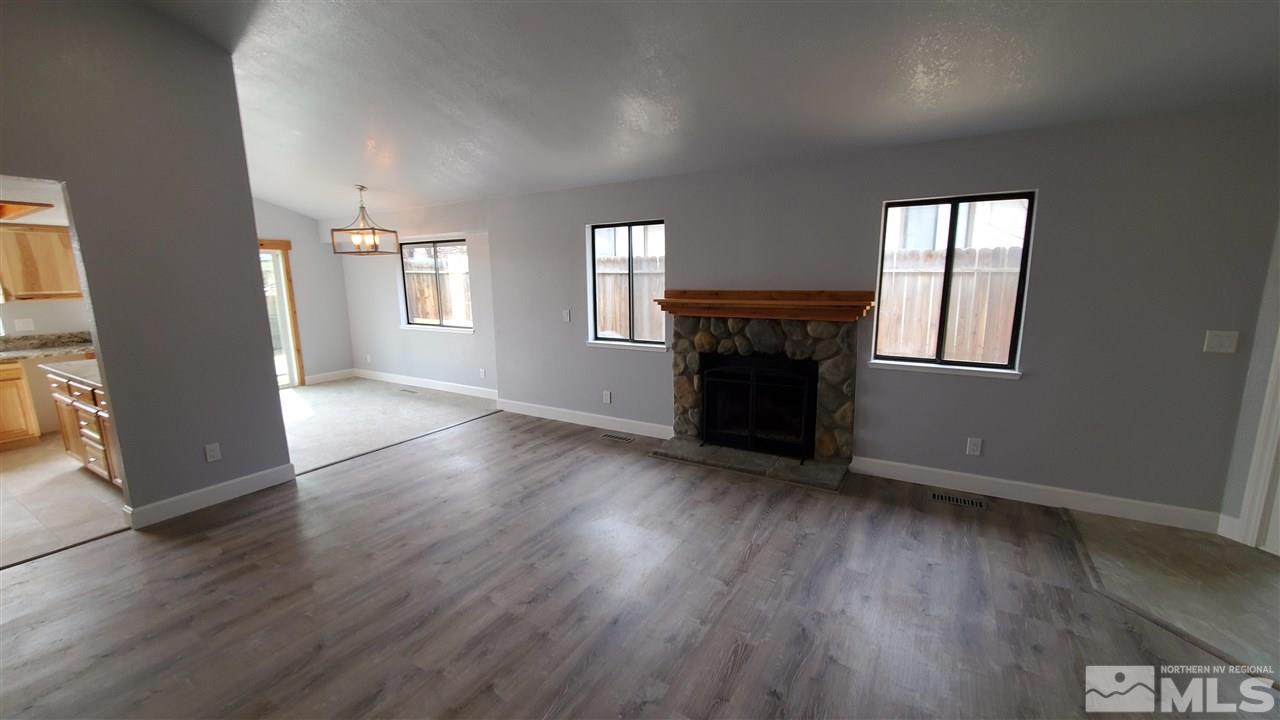 5880 Coyote Ridge Road Reno, NV 89523 - Photo 9 of 28 an empty room with wooden floor and windows