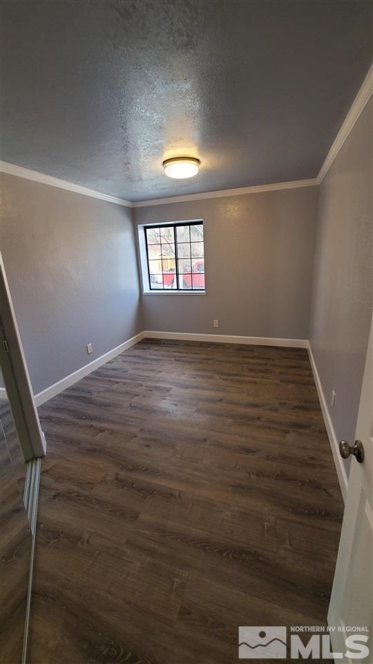 5880 Coyote Ridge Road Reno, NV 89523 - Photo 10 of 28 an empty room with wooden floor and windows