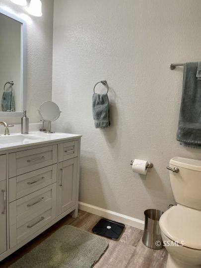 205 Chambers Street Ridgecrest, CA 93555 - Photo 12 of 32 a bathroom with a toilet sink and mirror