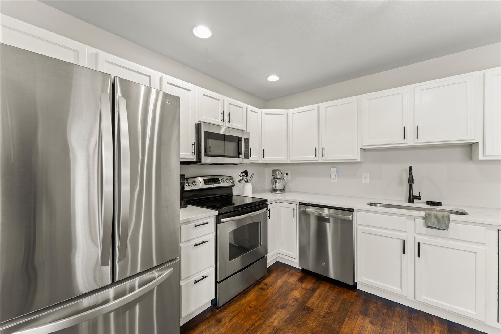 706 Northgate Drive St. Joseph, IL 61873 - Photo 12 of 33 a kitchen with white cabinets sink and stainless steel appliances