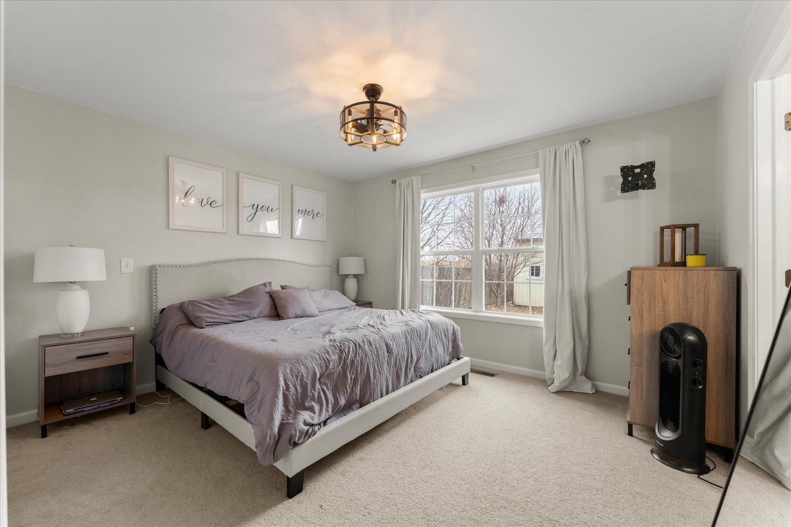 706 Northgate Drive St. Joseph, IL 61873 - Photo 16 of 33 a bedroom with a bed and a chandelier